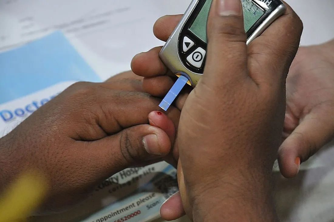a researcher examining a blood sample vial in a lab