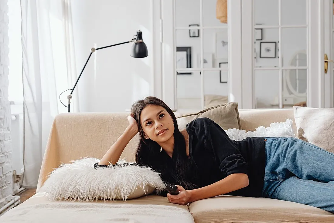 a person resting on a couch at home