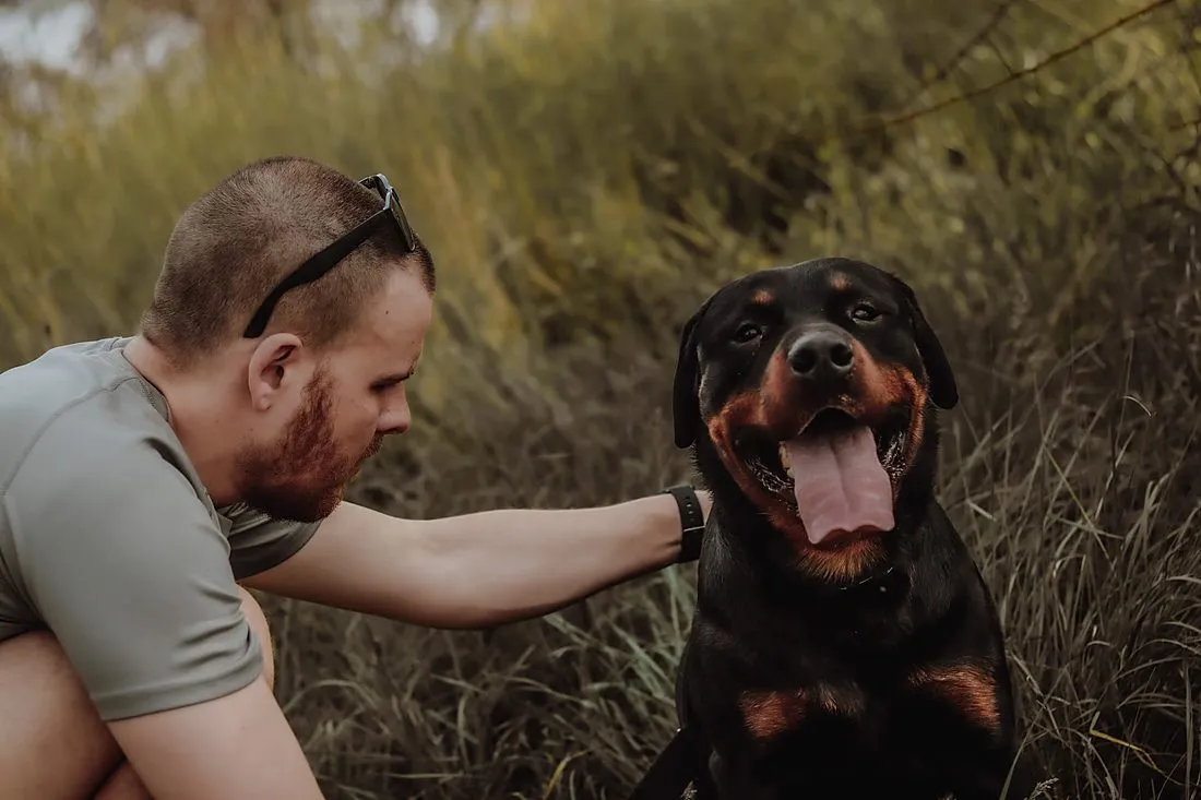 a man petting a dog