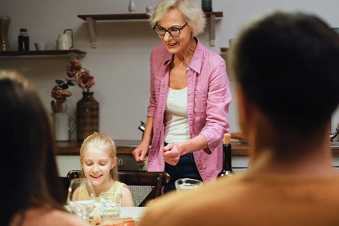 an elderly woman laughing with family