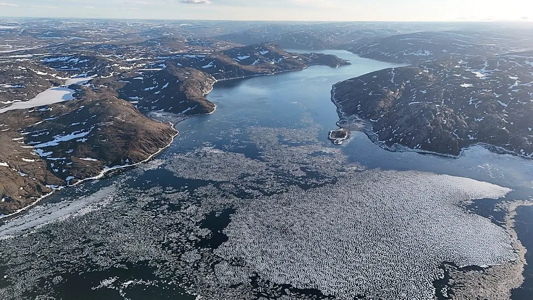 an aerial view of a remote northern Canadian community on a frozen bay