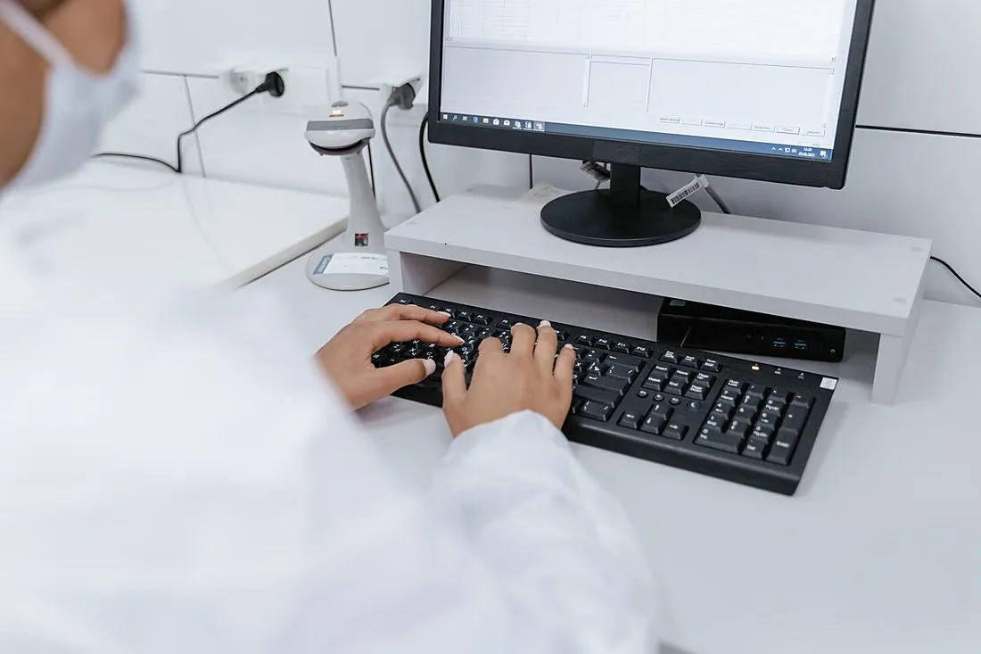 a person typing quickly on a keyboard in a lab