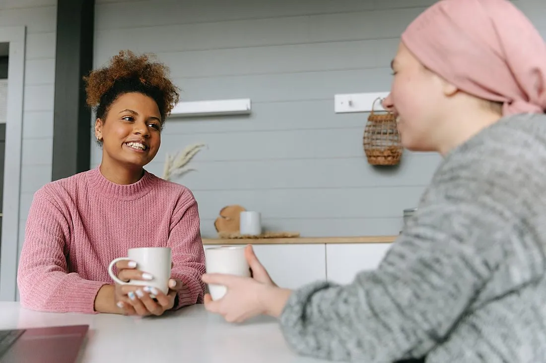 two people talking over coffee