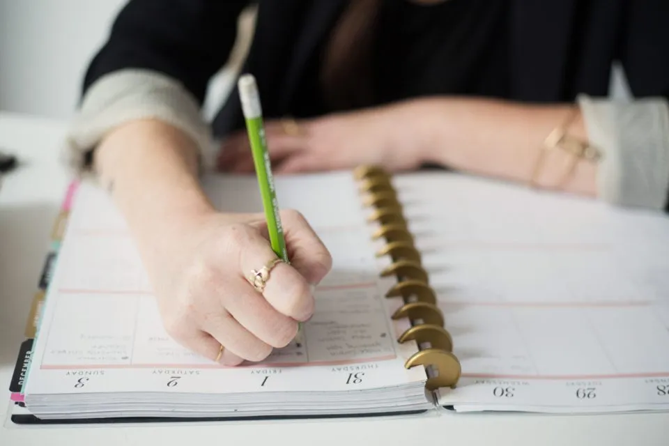 a person writing in a journal