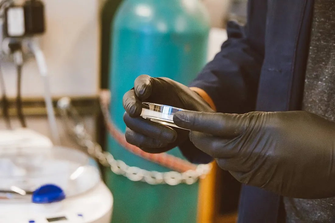 an oceanographer collecting sediment cores aboard a research ship