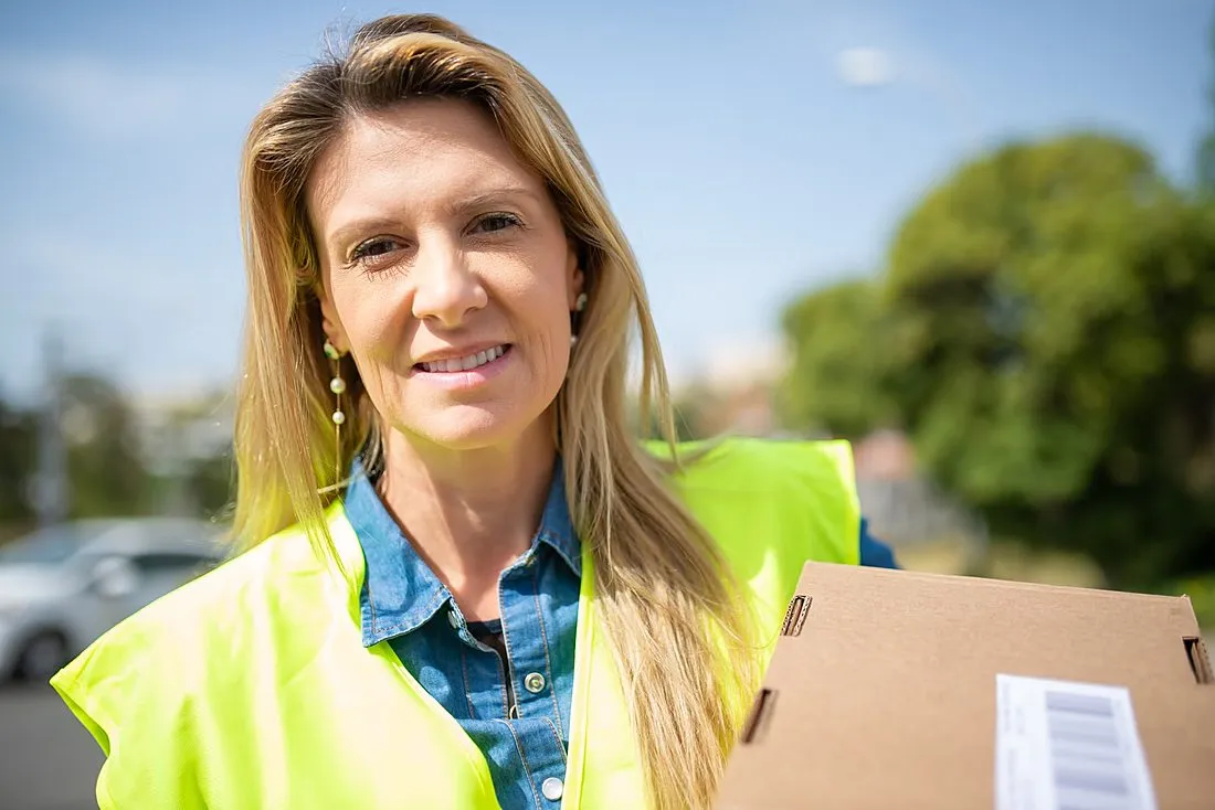 a postal worker holding a baby