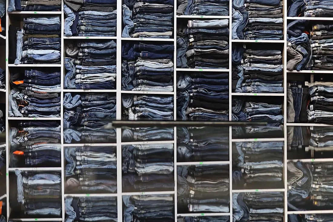 a rack of folded clothing in a store