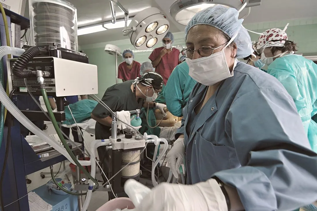 a surgeon carrying an organ transport cooler