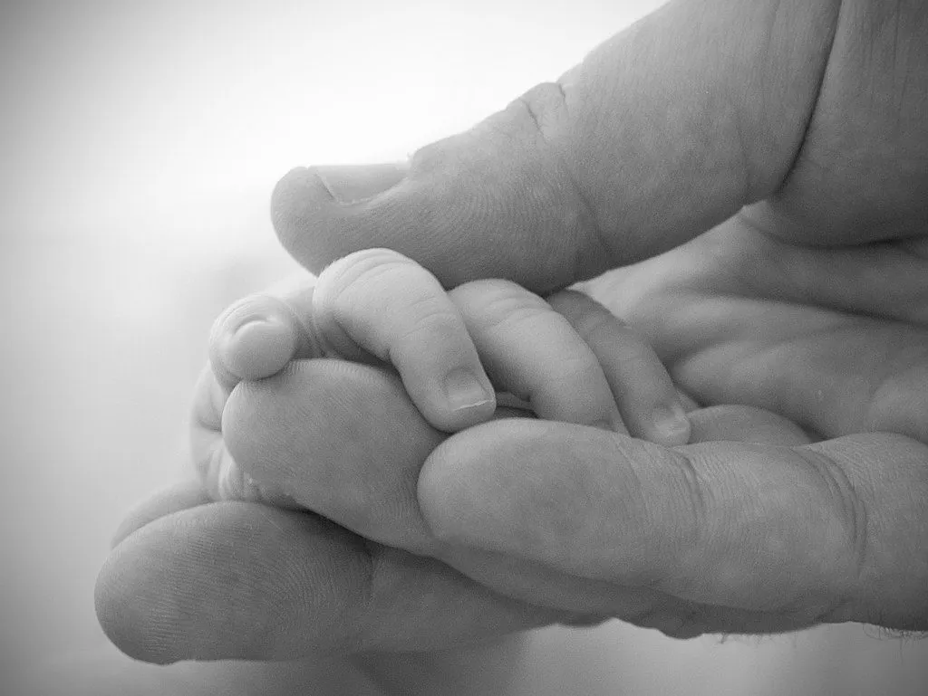father holding newborn baby