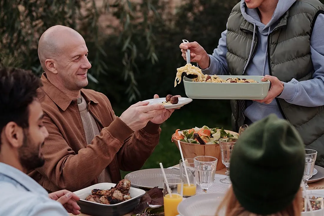 neighbors sharing a meal outdoors