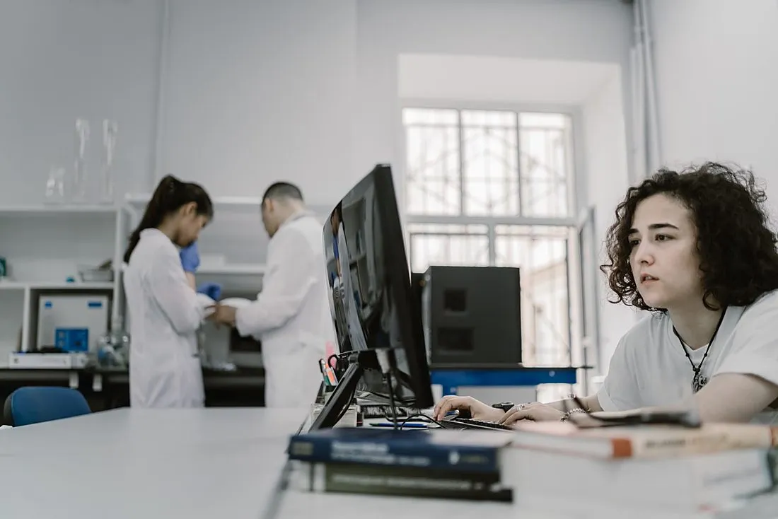 a woman scientist working at a laboratory computer